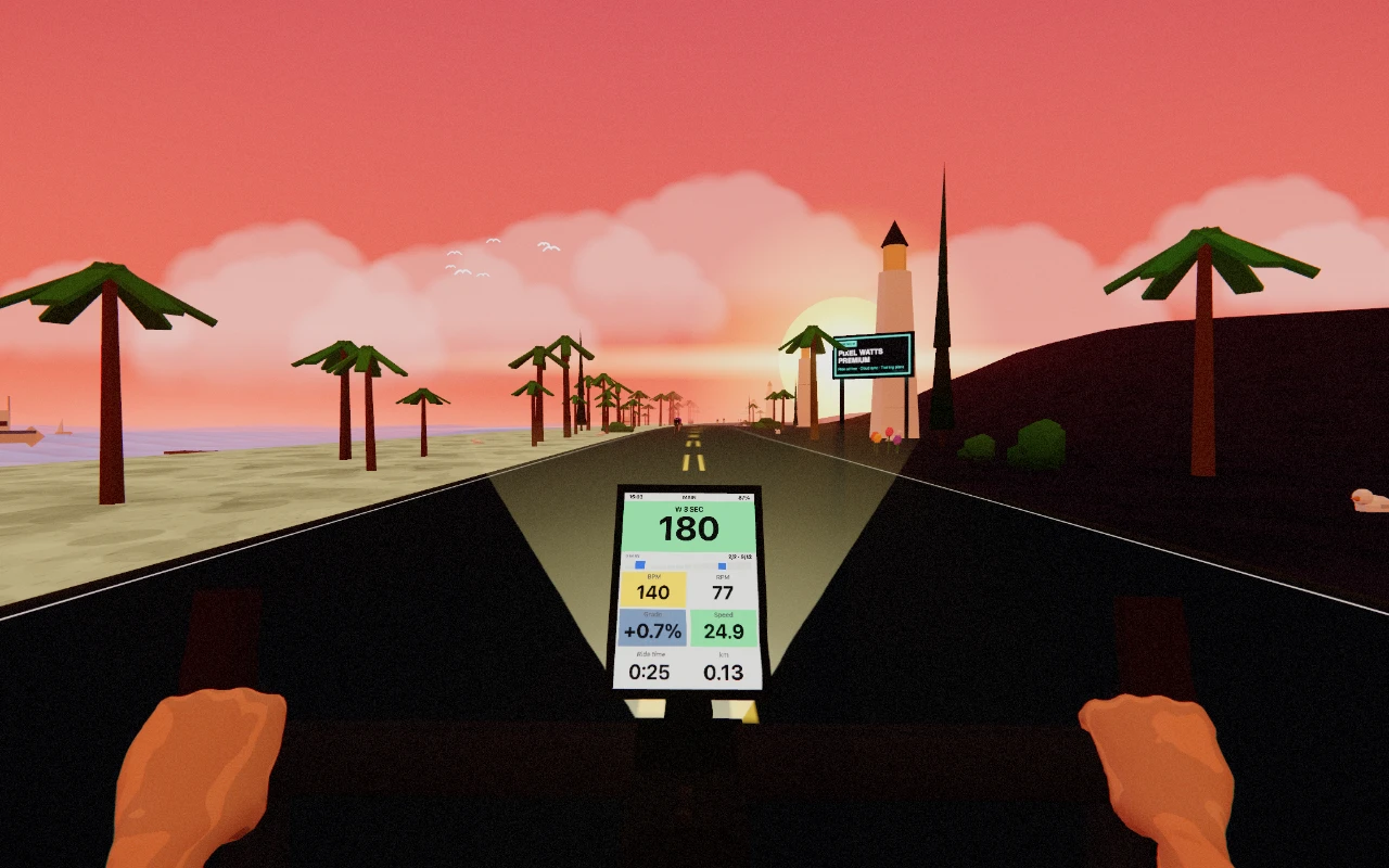 Pixel Watts in play: the view over the handlebars onto a coastal road at sunset, palm trees along the verge, and the bike computer in the middle reading 180 watts, 140 bpm, 77 rpm and 24.9 km/h on a 0.7 per cent grade.